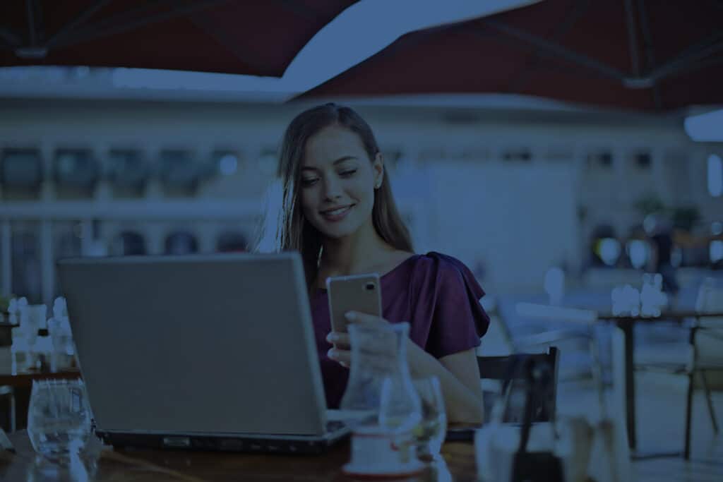 Woman in purple shirt using cloud communication solutions at winery
