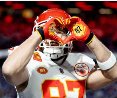 travis kelce making a heart gesture in Kansas City, representing teamwork and local pride with Towner Communications