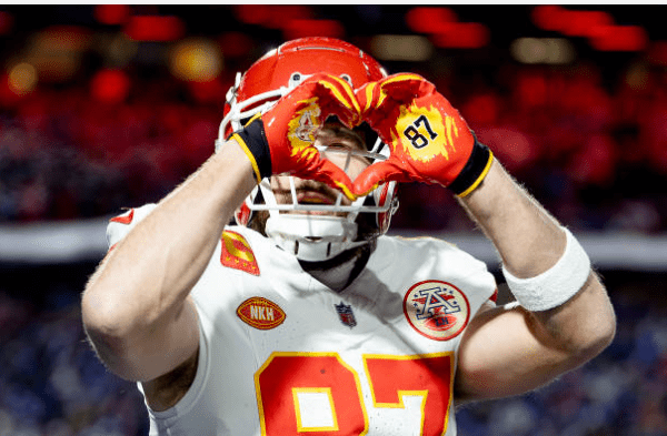 travis kelce making a heart gesture in Kansas City, representing teamwork and local pride with Towner Communications