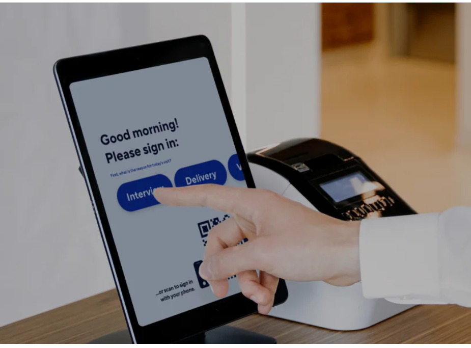 Person using digital sign-in tablet for visitor management and access control at Kansas City business