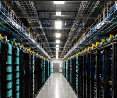 High-density data center cabling with organized fiber backbone infrastructure in a mission-critical environment.