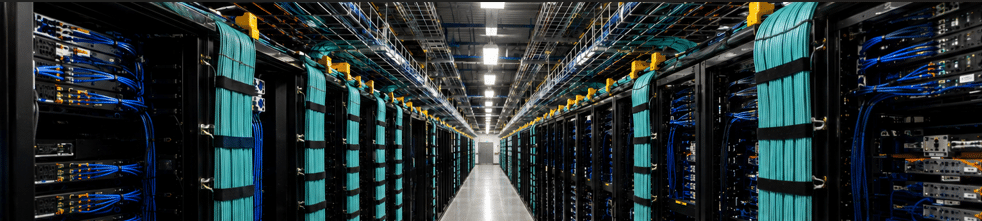 High-density data center cabling with organized fiber backbone infrastructure in a mission-critical environment.